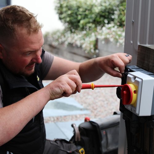 Electrician working on an outside isolator